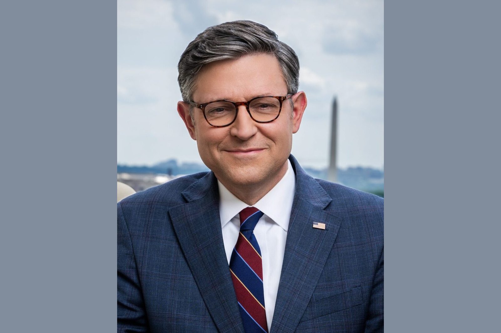 Portrait of House Speaker Mike Johnson in a dark suit and tie.