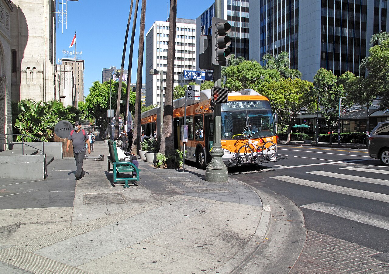 Looking east on Wilshire Boulevard at Normandie Avenue in Los Angeles, a Metro bus in traffic