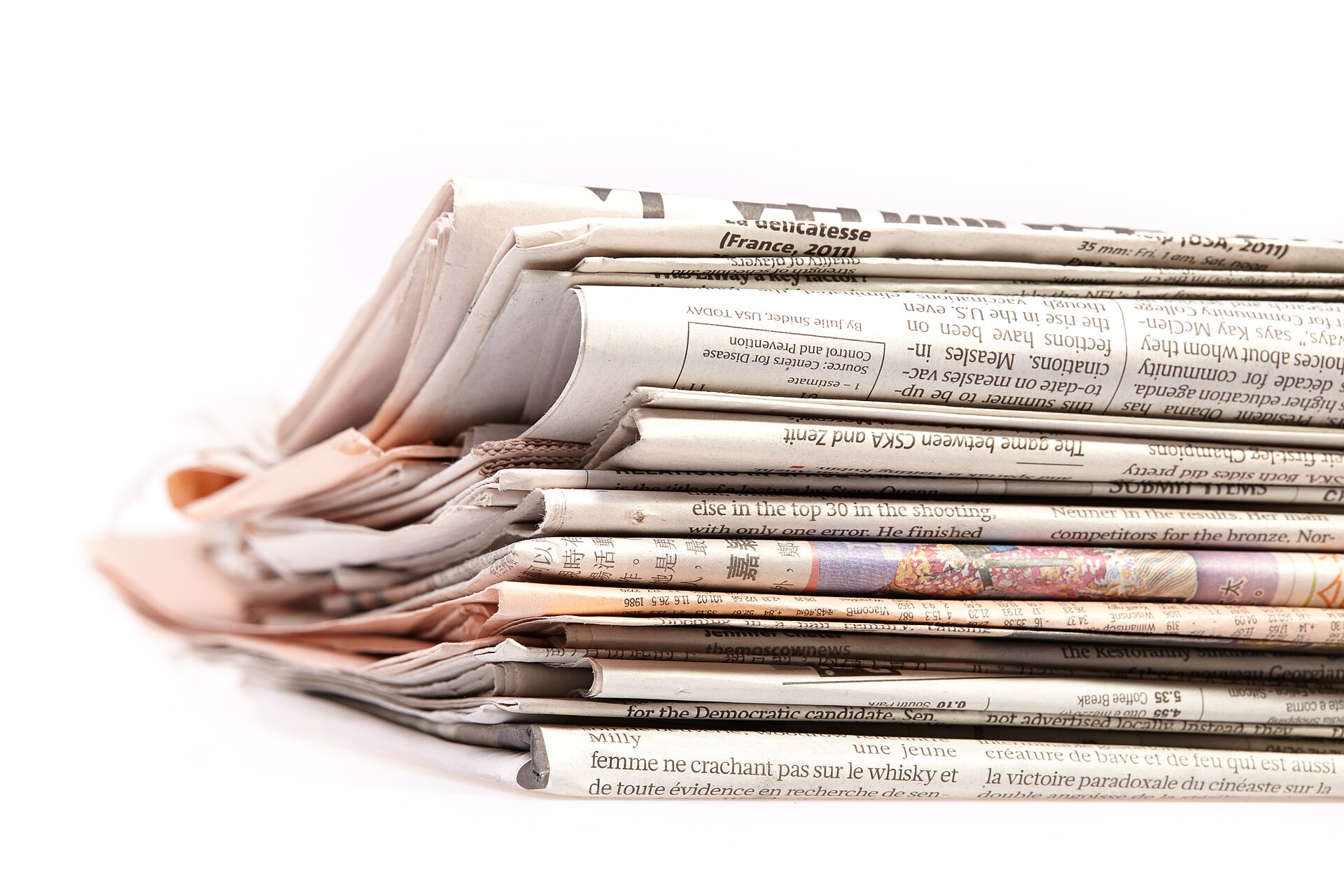 A stack of folded newspapers