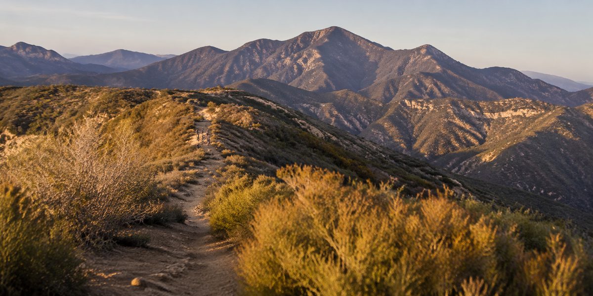 A hiking trail winding along a golden ridgeline