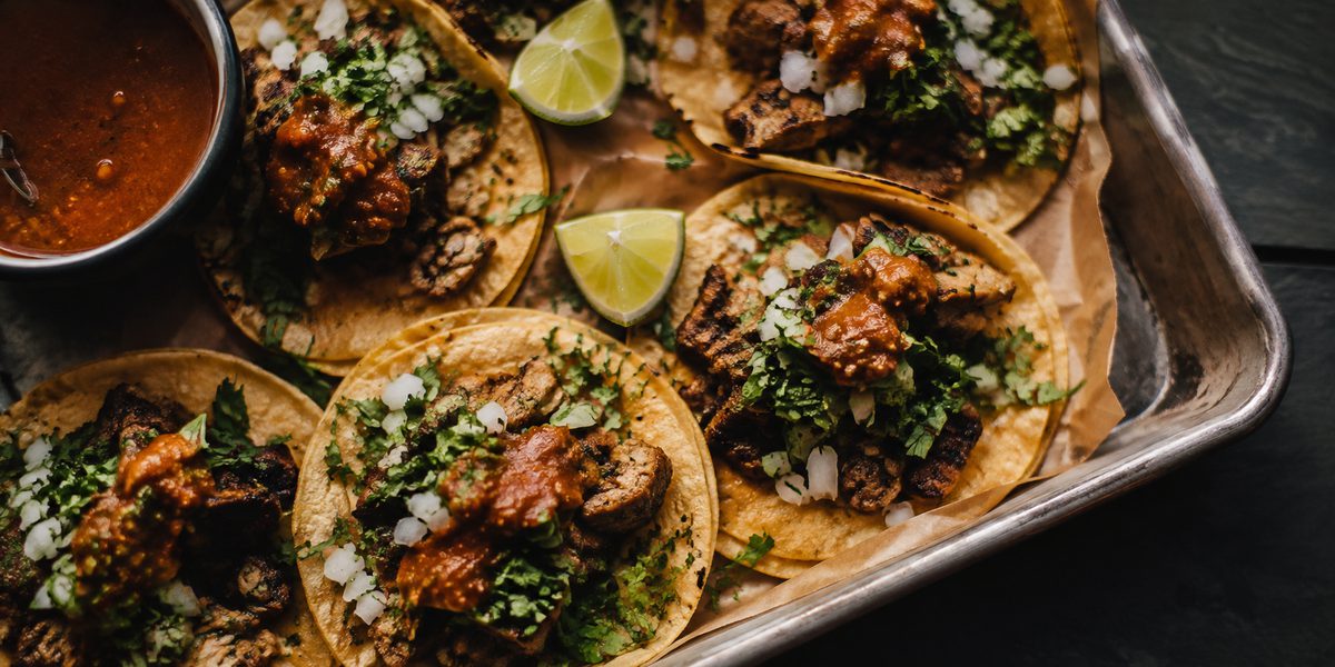 Street tacos on a metal tray