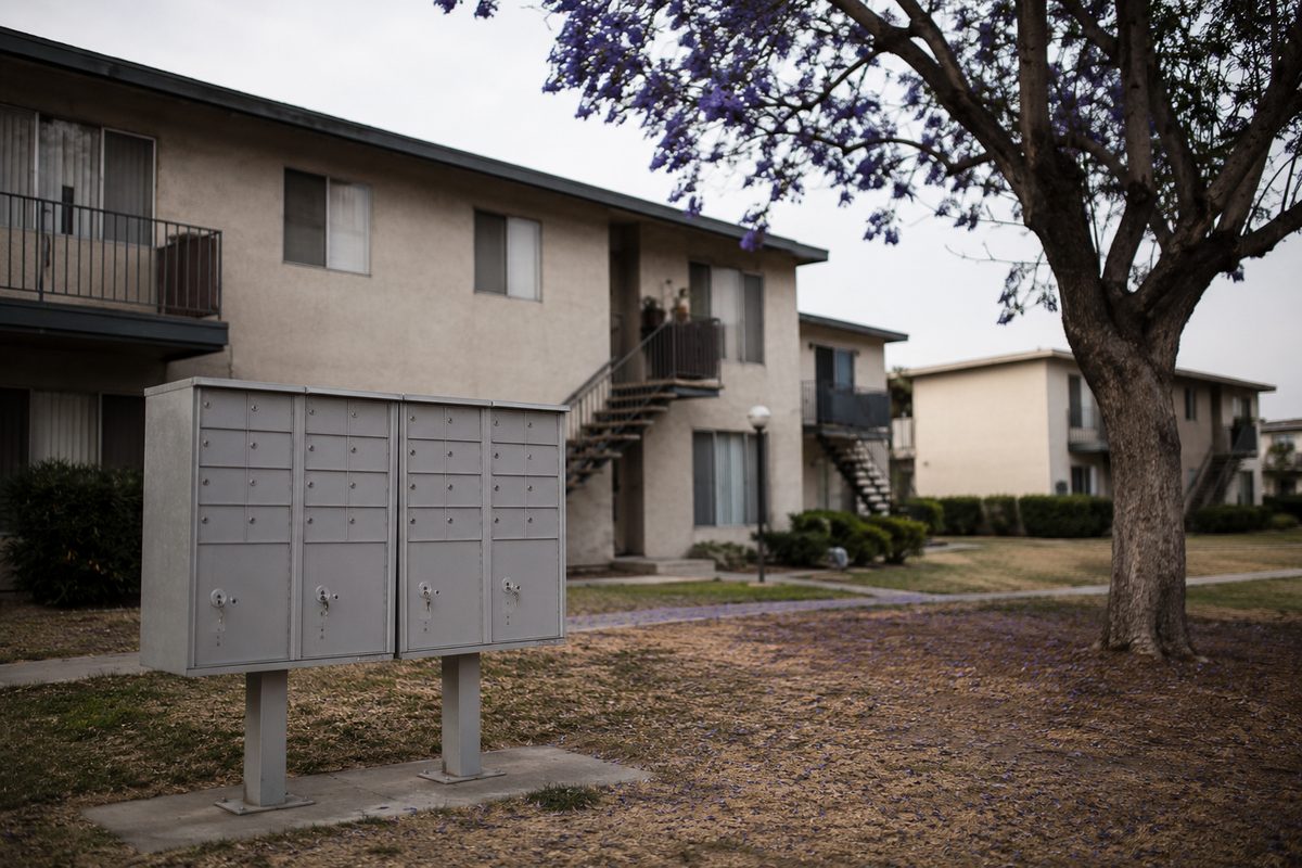 A low-rise apartment building courtyard in Los Angeles County, with walkways, mailboxes and no visible signage or people, illustrating public housing and the county waitlist.