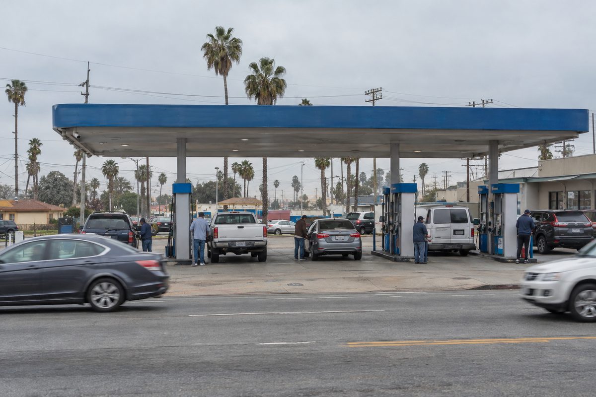 Drivers pump gas at a station on a Los Angeles boulevard under an overcast sky as oil prices climbed past $105 a barrel.