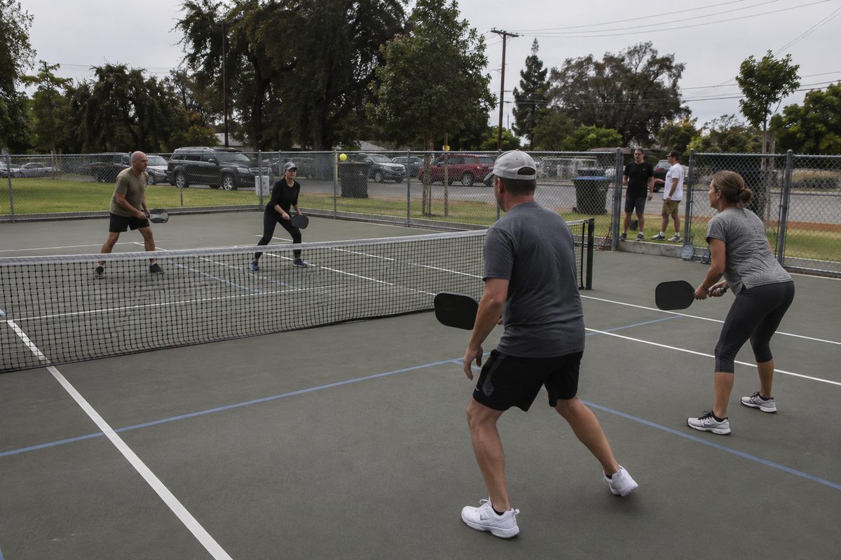 Photo illustration accompanying “Pickleball Courts Cost $25 an Hour at County Parks and $6 at City Parks.”.