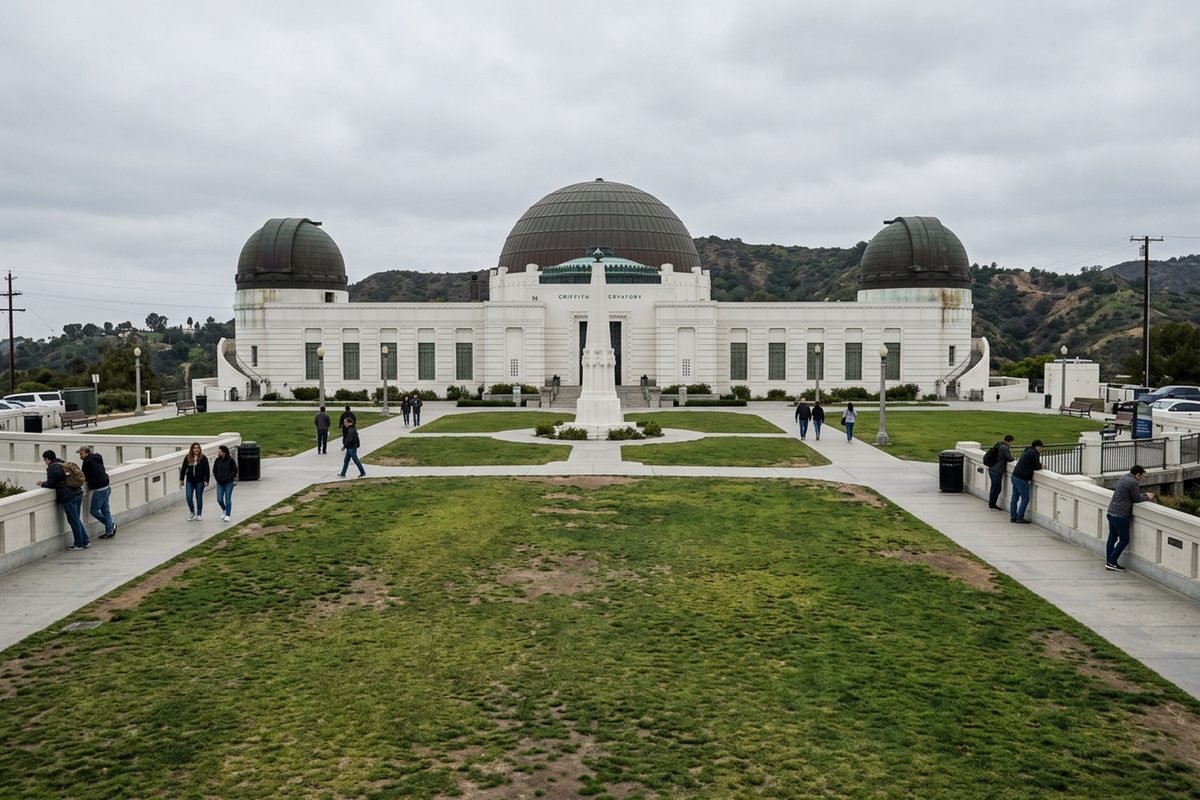 Visitors walk the lawn in front of Griffith Observatory's domes on an overcast afternoon in Los Angeles.