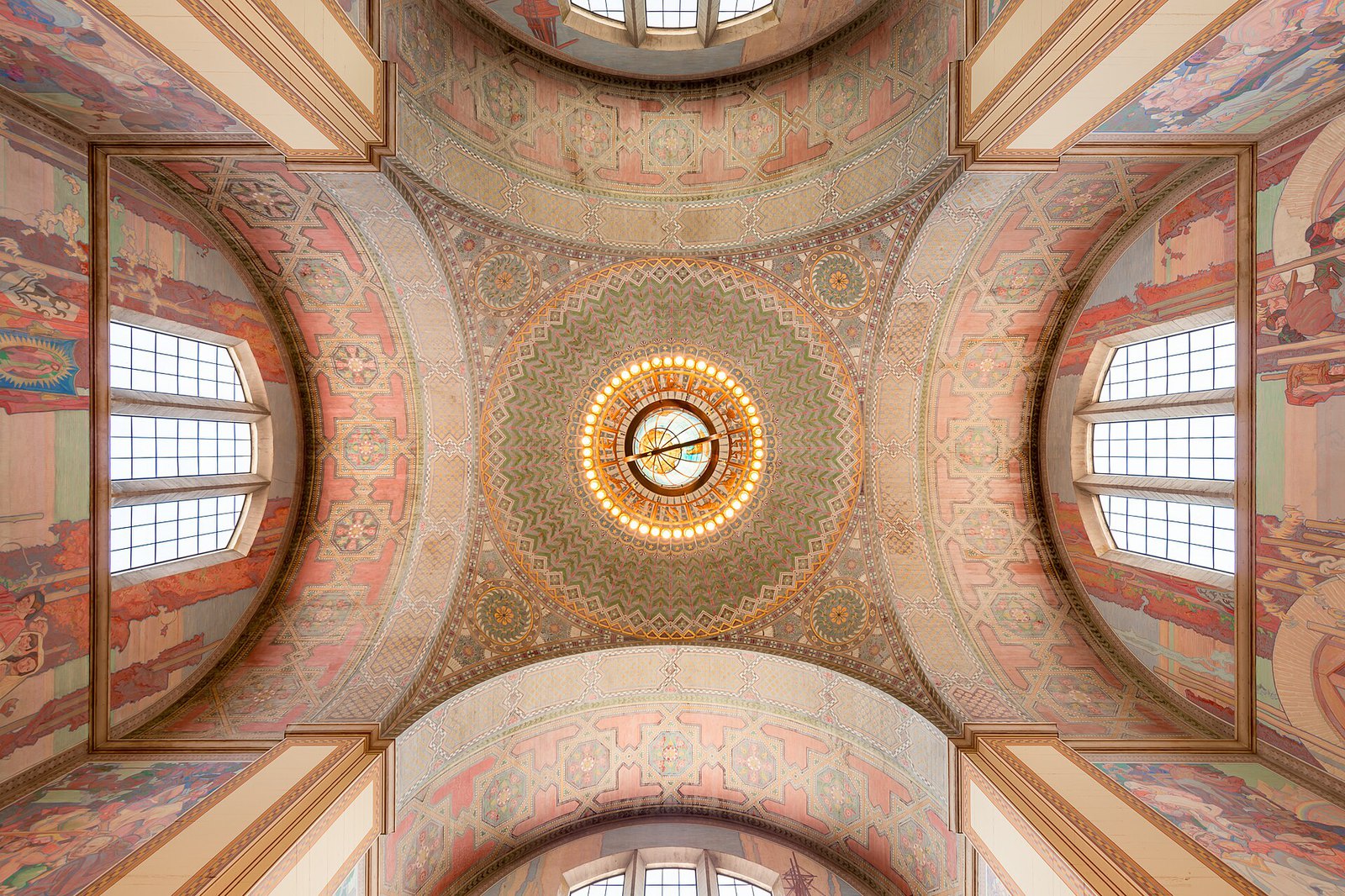 The painted rotunda ceiling of the Los Angeles Central Library, seen from directly below, with a large chandelier at its center