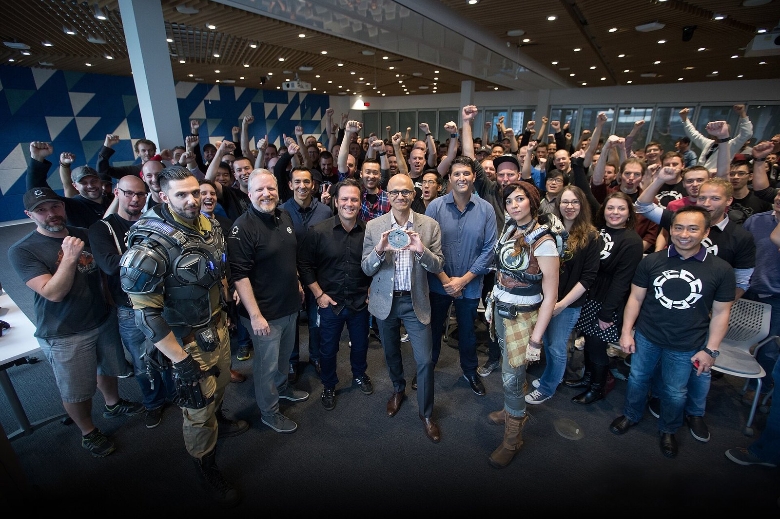 Satya Nadella, CEO of Microsoft, holds the gold master disc of Gears of War 4 at The Coalition game development studio in 2016.
