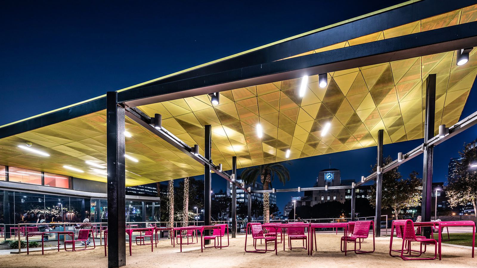An outdoor dining patio in downtown Los Angeles at night
