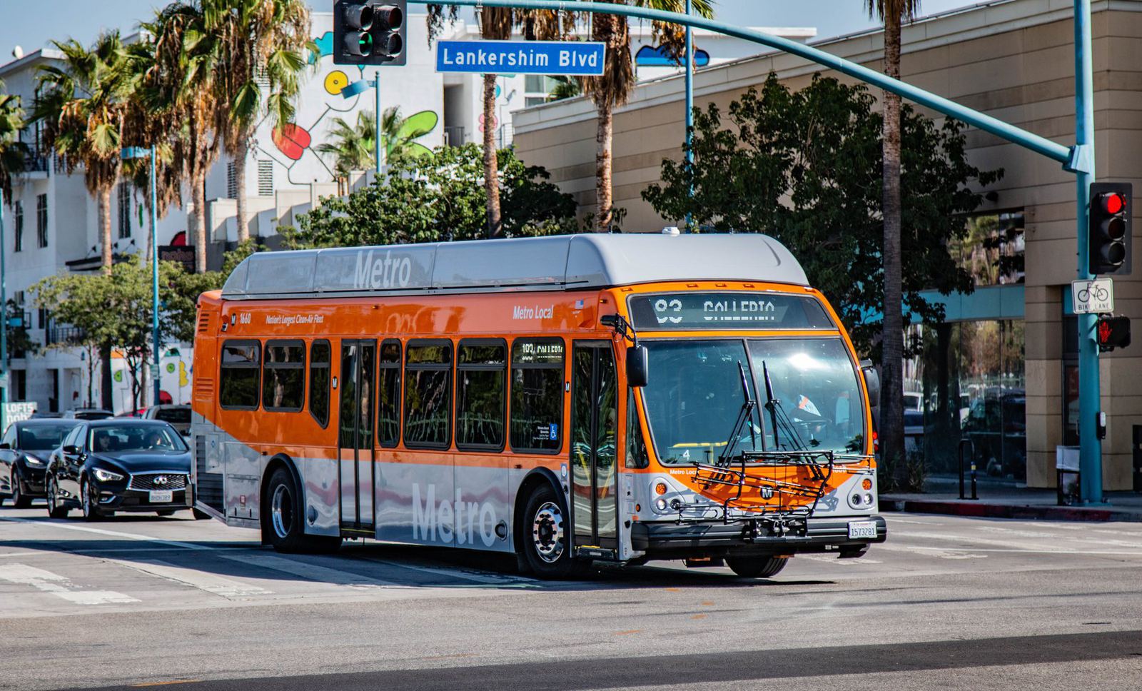 An orange Metro Local bus turning onto Lankershim Boulevard in North Hollywood
