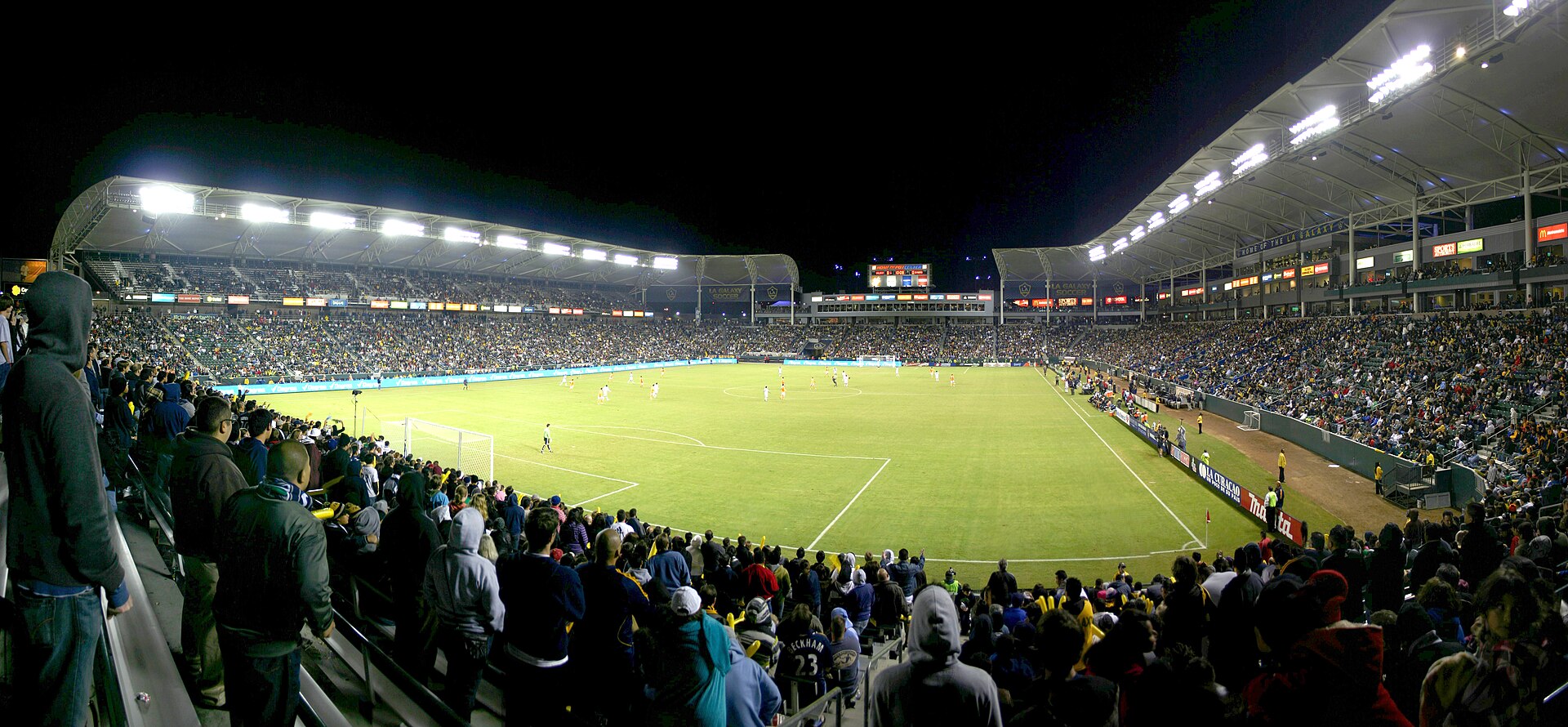 A packed soccer stadium under lights at night